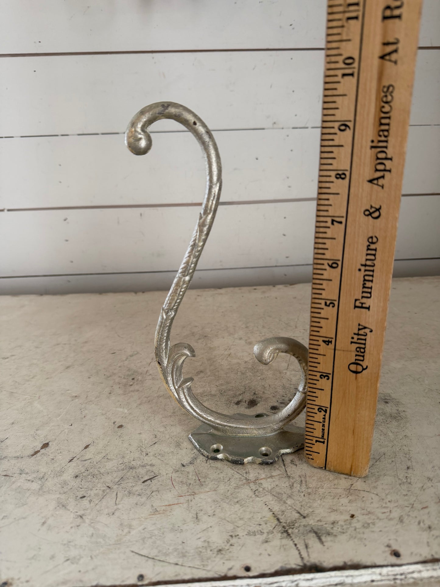 Silver colored, cast-iron hat, hook