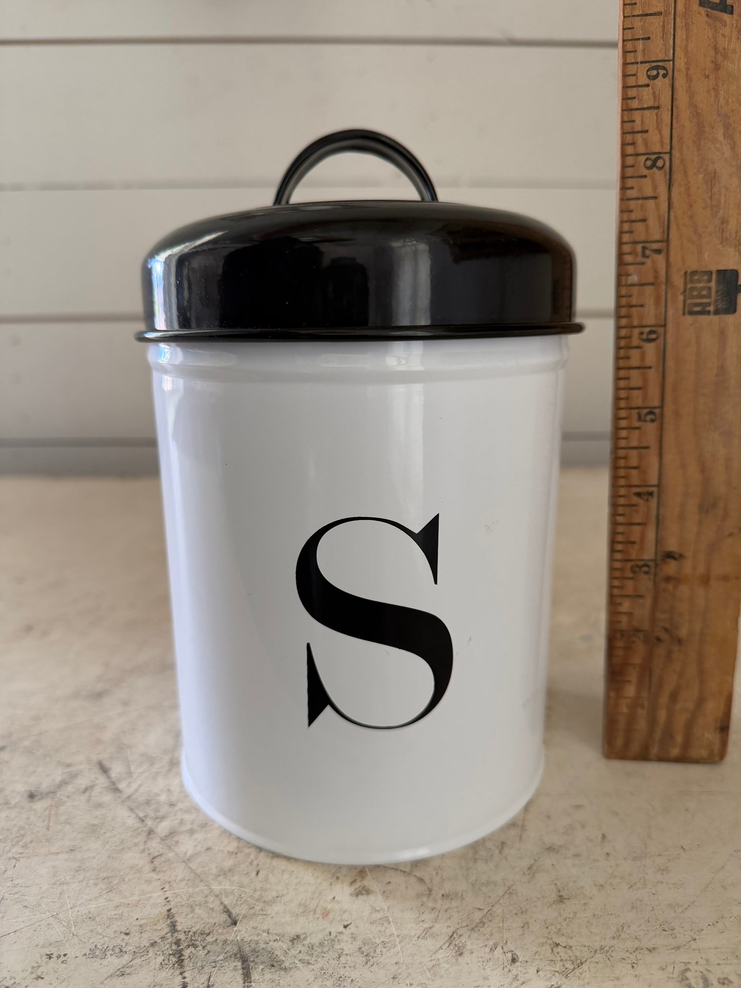 Metal enamel canister with an S on it will get makeover