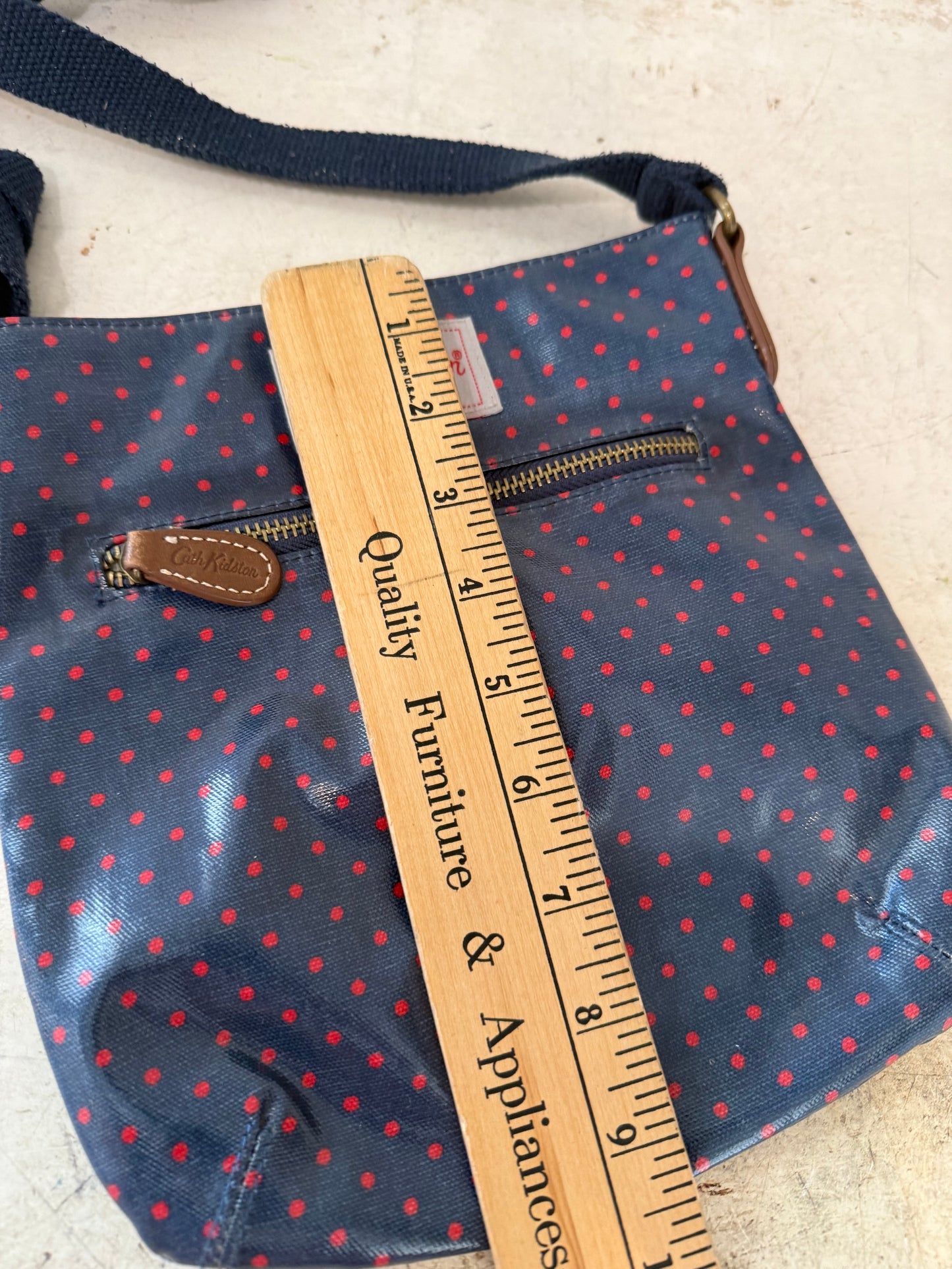 Cath Kidston bag with a navy blue and red polka dot print