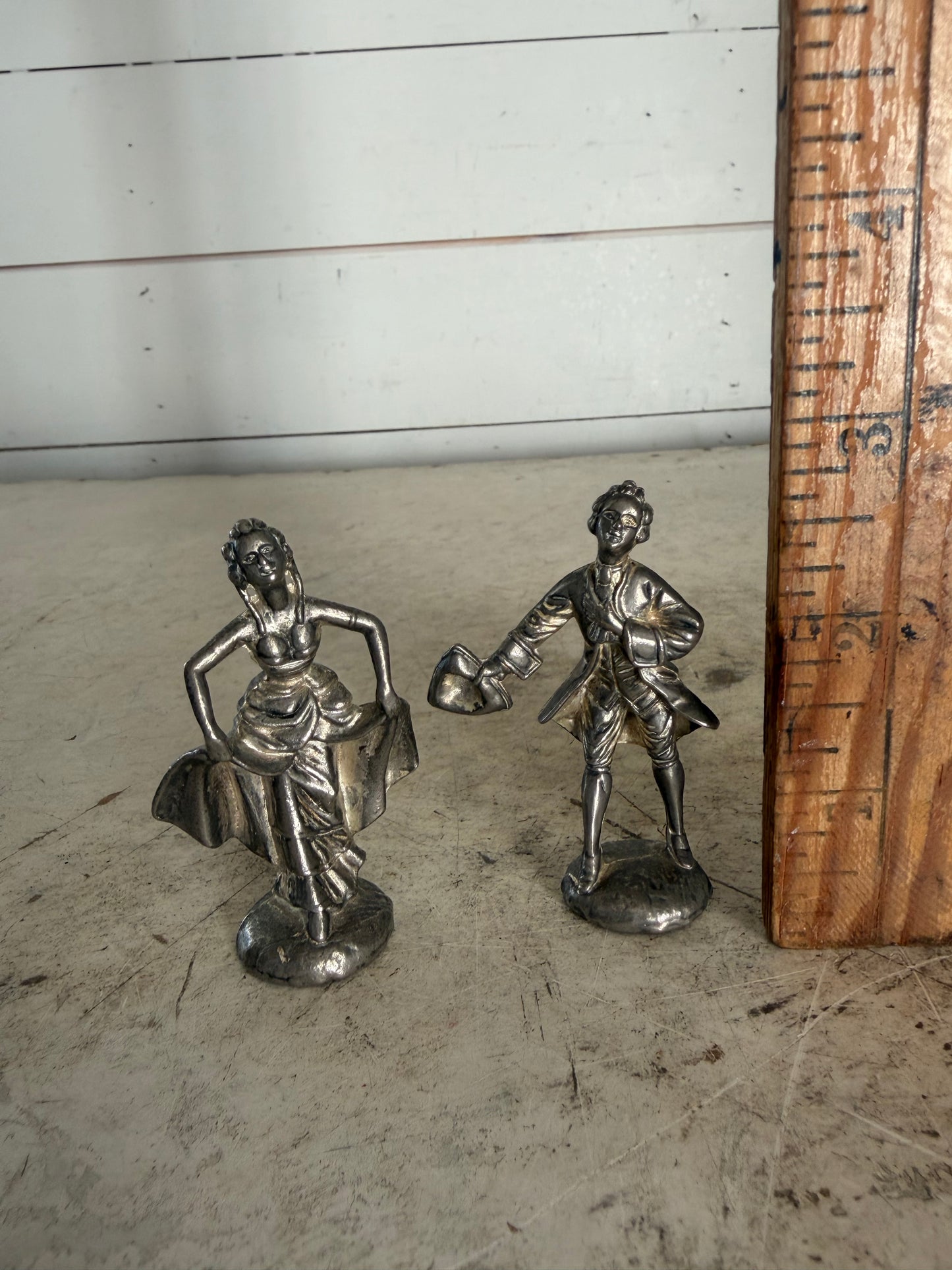 Pair of vintage pewter figurines depicting a courting lady and gentleman