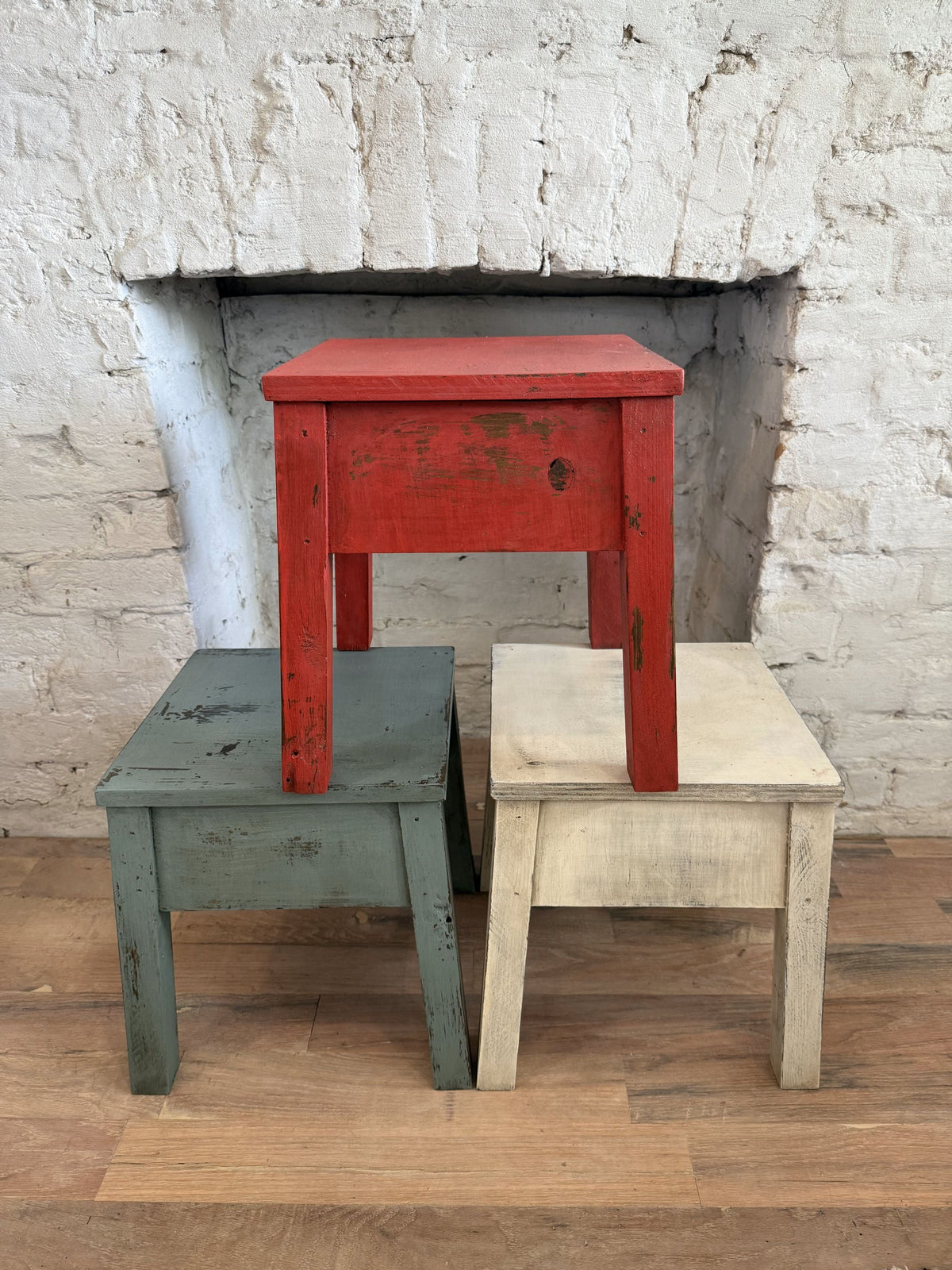 3 Stools painted in Milk Paint displayed in front of fireplace