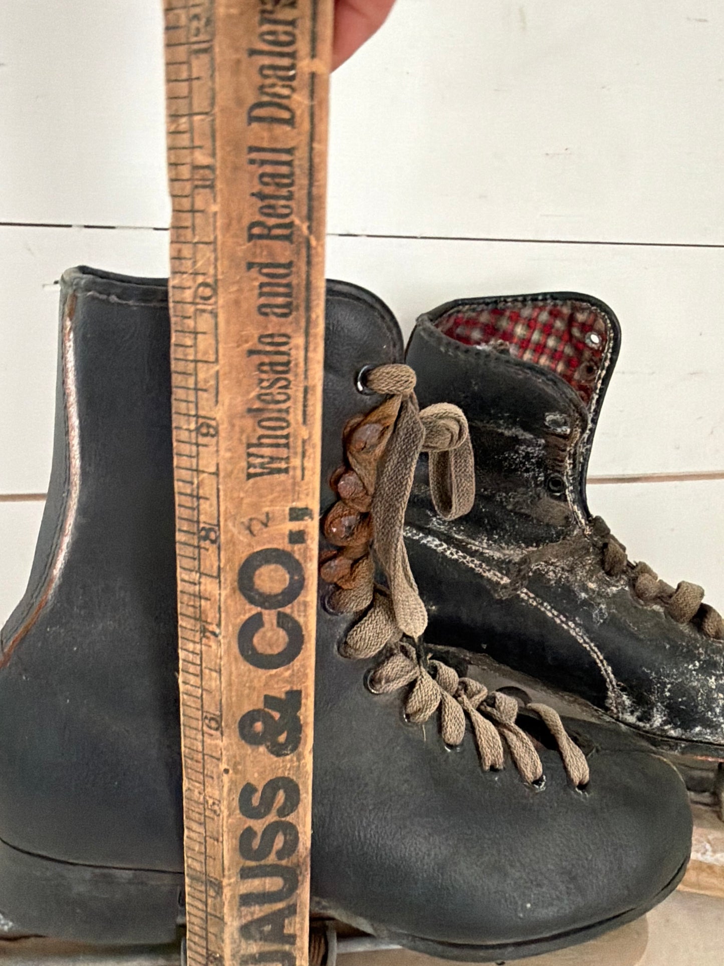 Set of black antique ice skates with wood guards