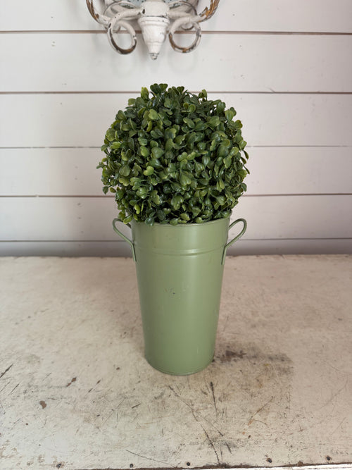 Artificial boxwood topiary in painted metal flower bucket