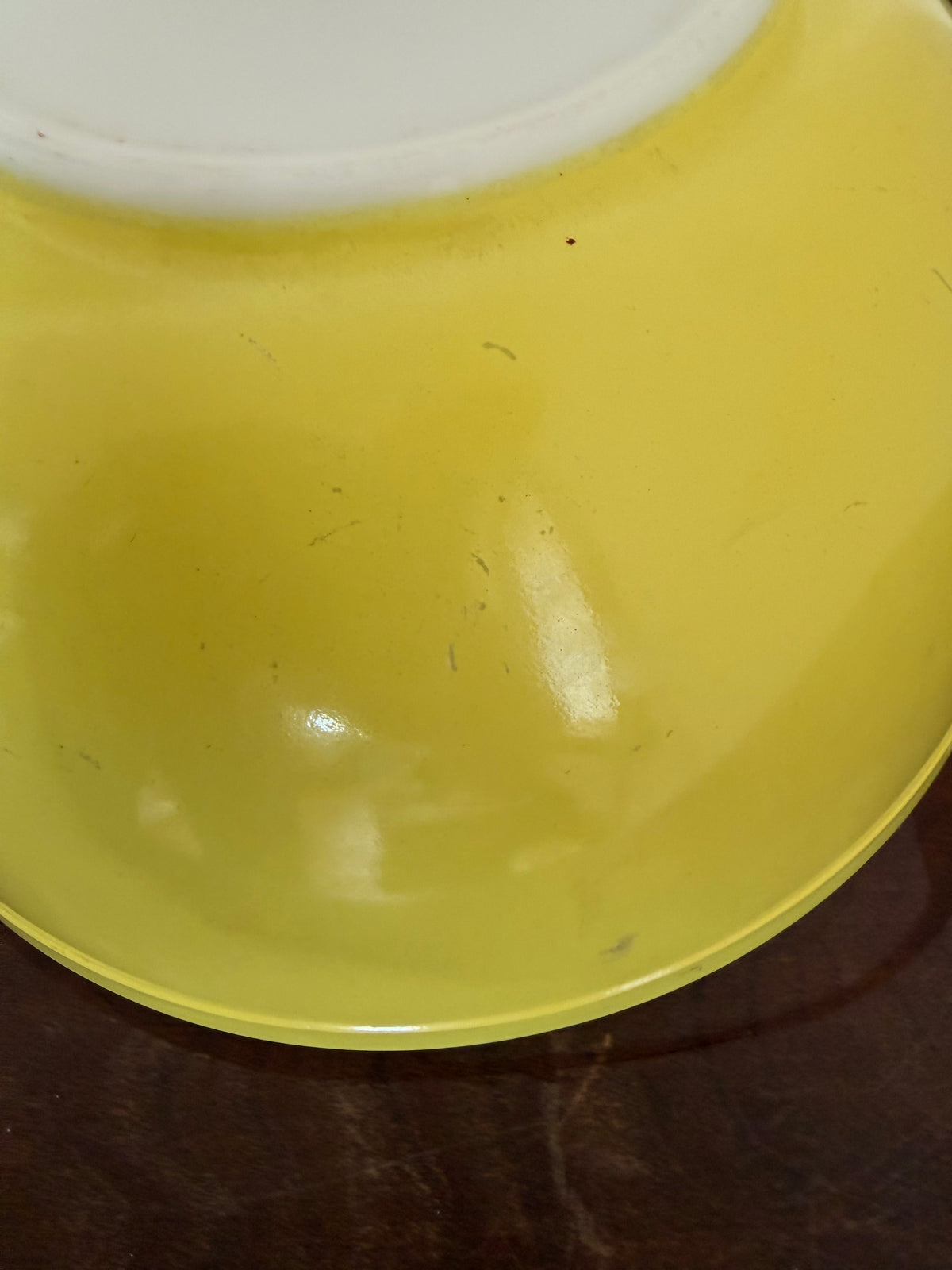 Vintage yellow Pyrex Mixing Bowl with a white interior - Has Some Wear