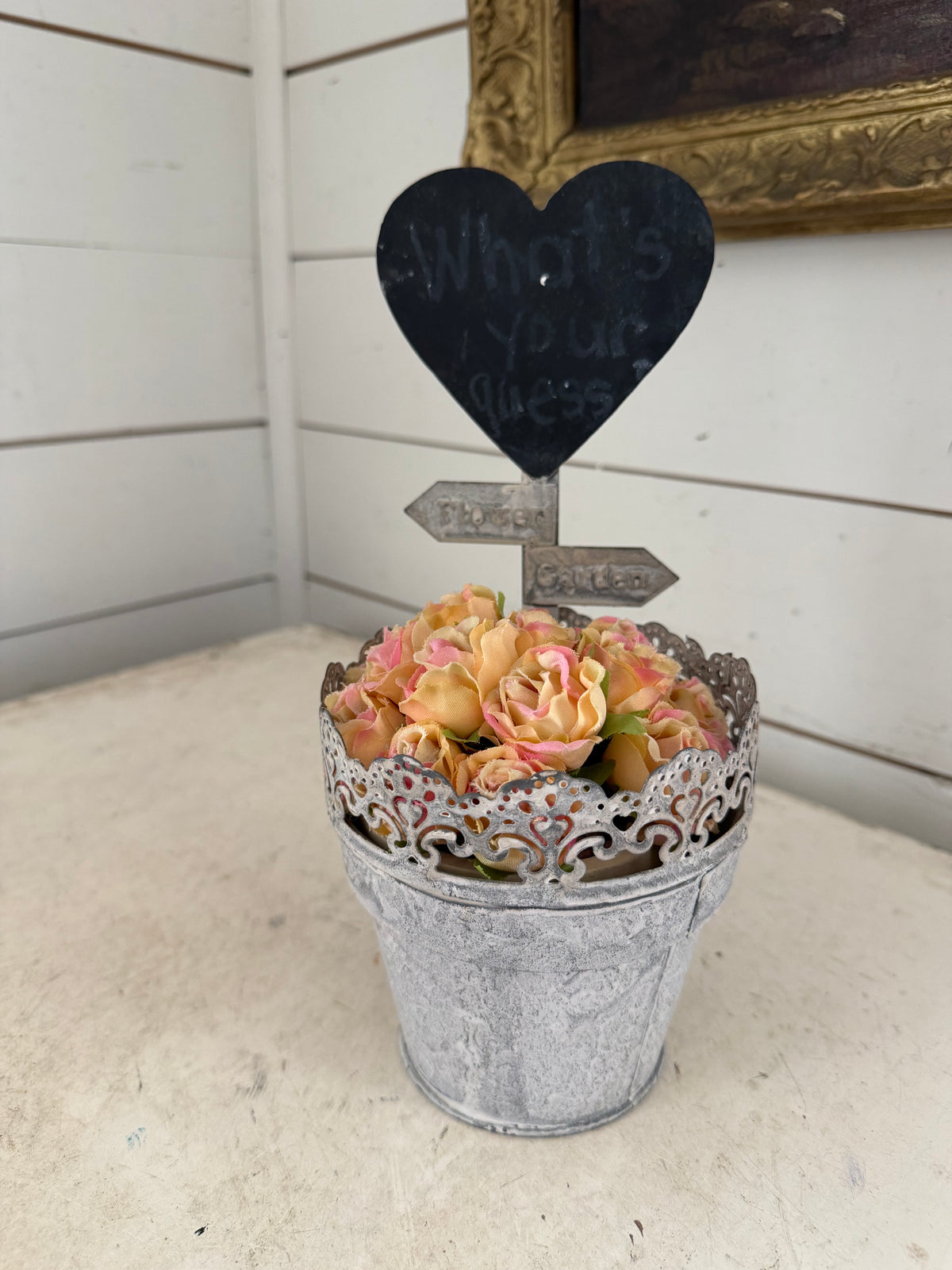 Rustic galvanized metal pot filled with artificial peach and pink roses, featuring a heart-shaped chalkboard sign- heart will get makeover