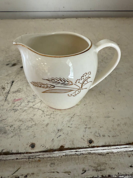 Homer Laughlin mid-century wheat design creamer has some chips