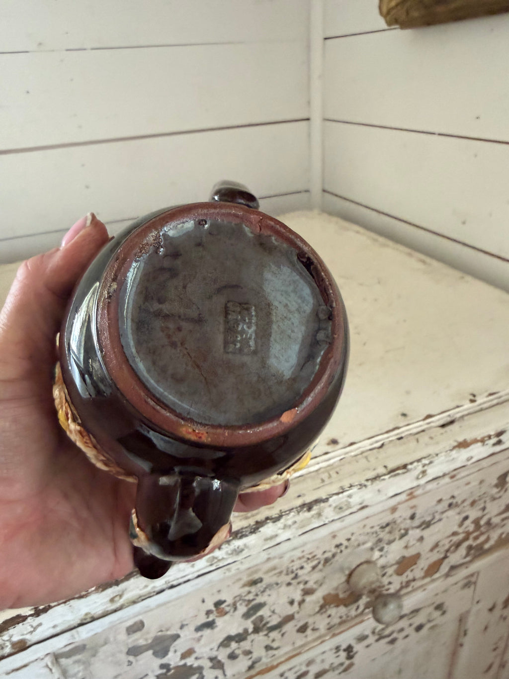 vintage Japanese redware teapot featuring a dark brown glaze