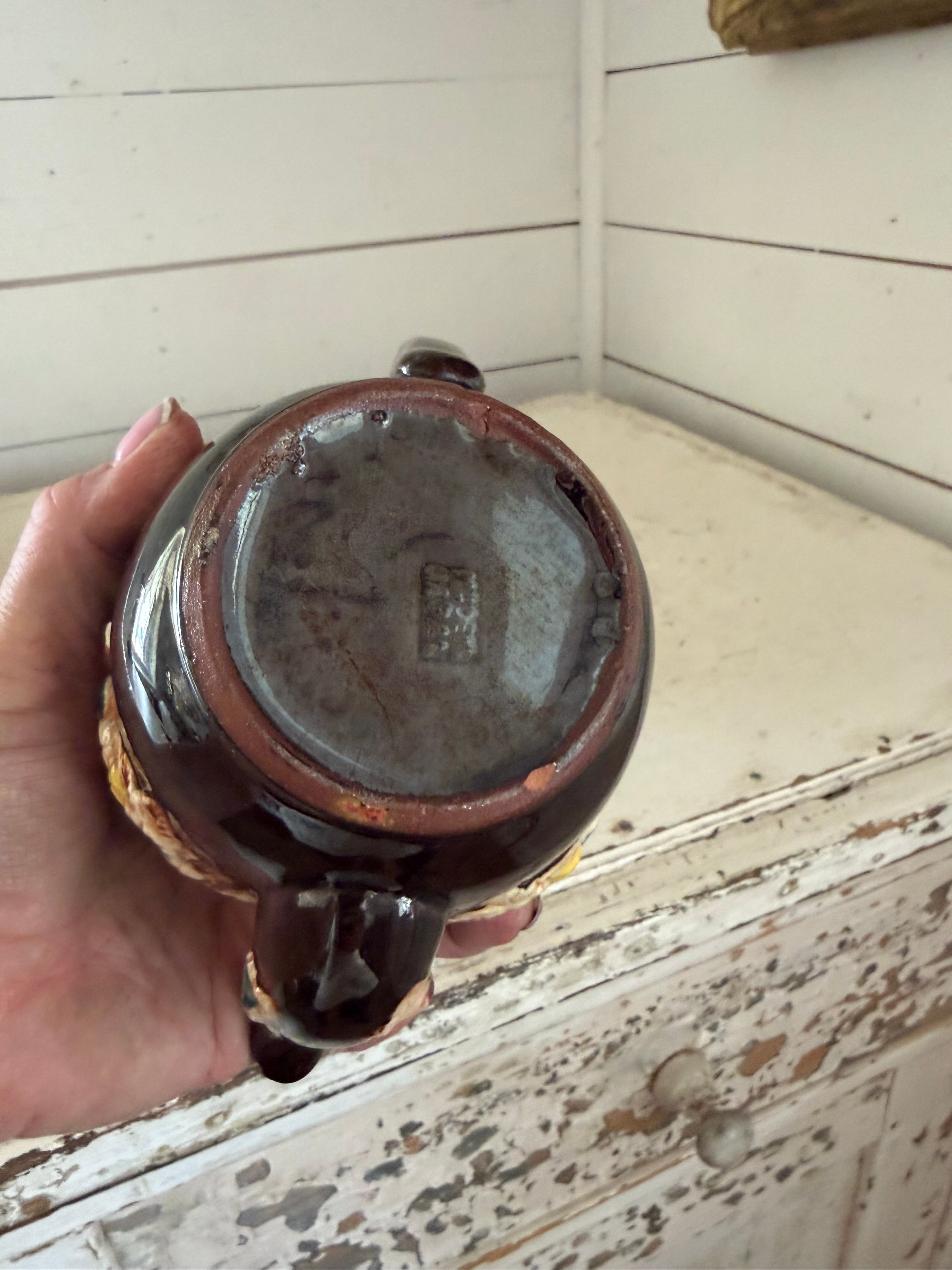 vintage Japanese redware teapot featuring a dark brown glaze