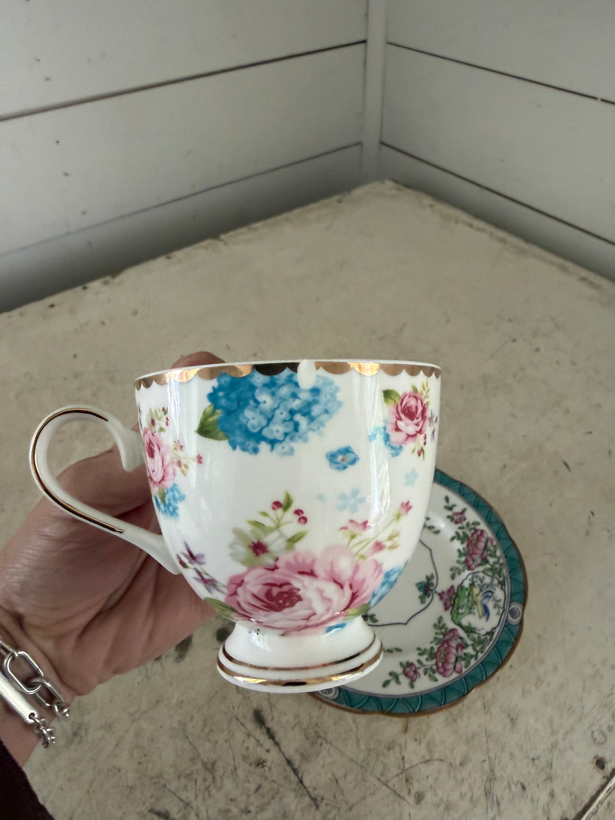 Mismatched, teacup, and saucer as is small chip