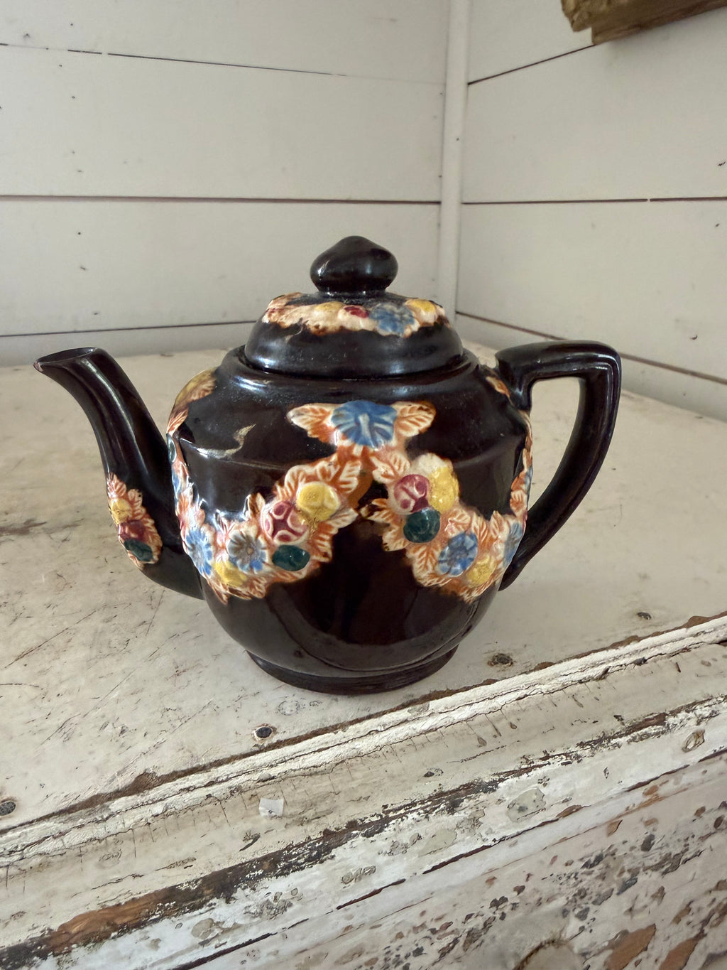 vintage Japanese redware teapot featuring a dark brown glaze