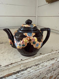 vintage Japanese redware teapot featuring a dark brown glaze