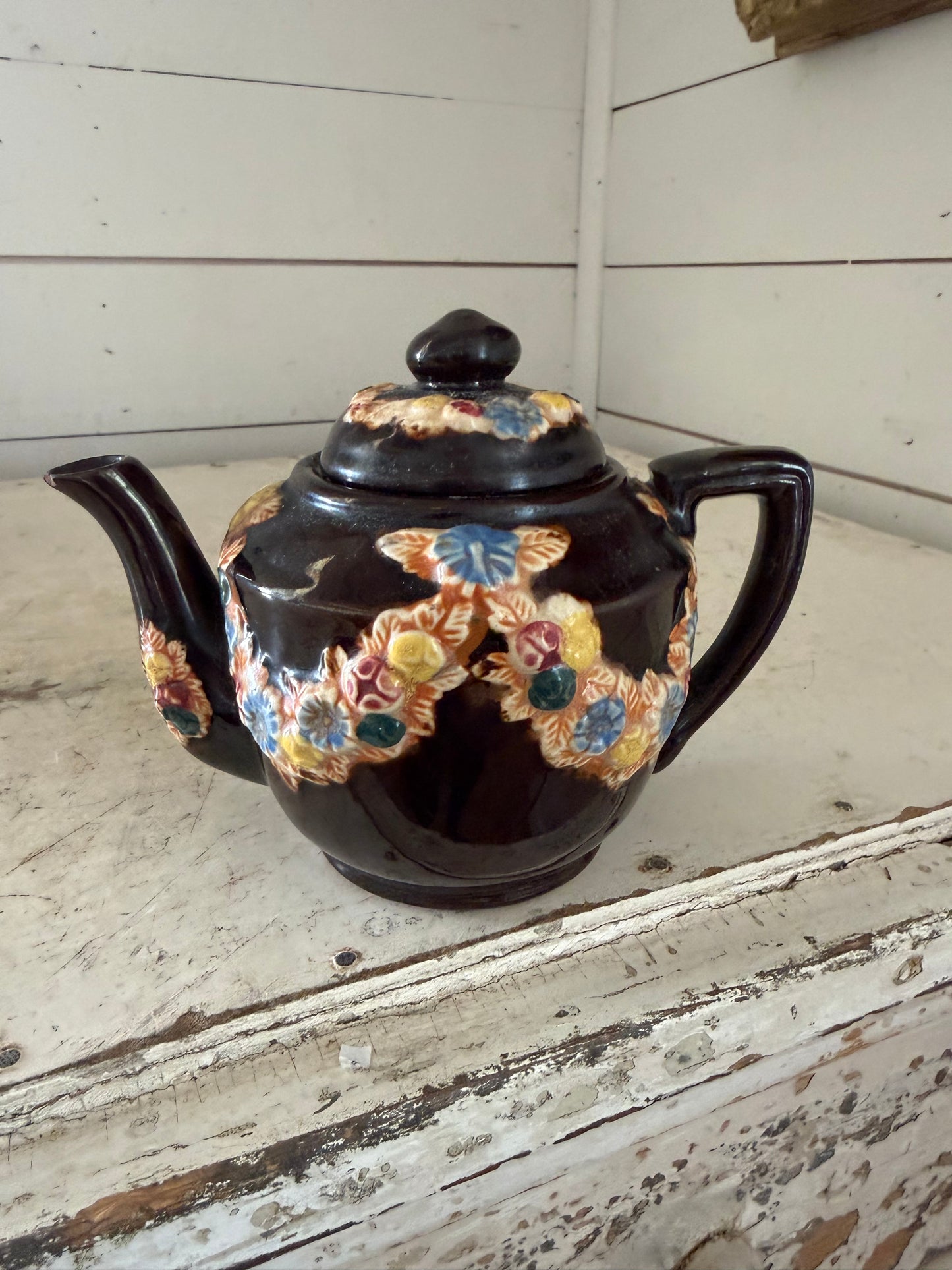 vintage Japanese redware teapot featuring a dark brown glaze