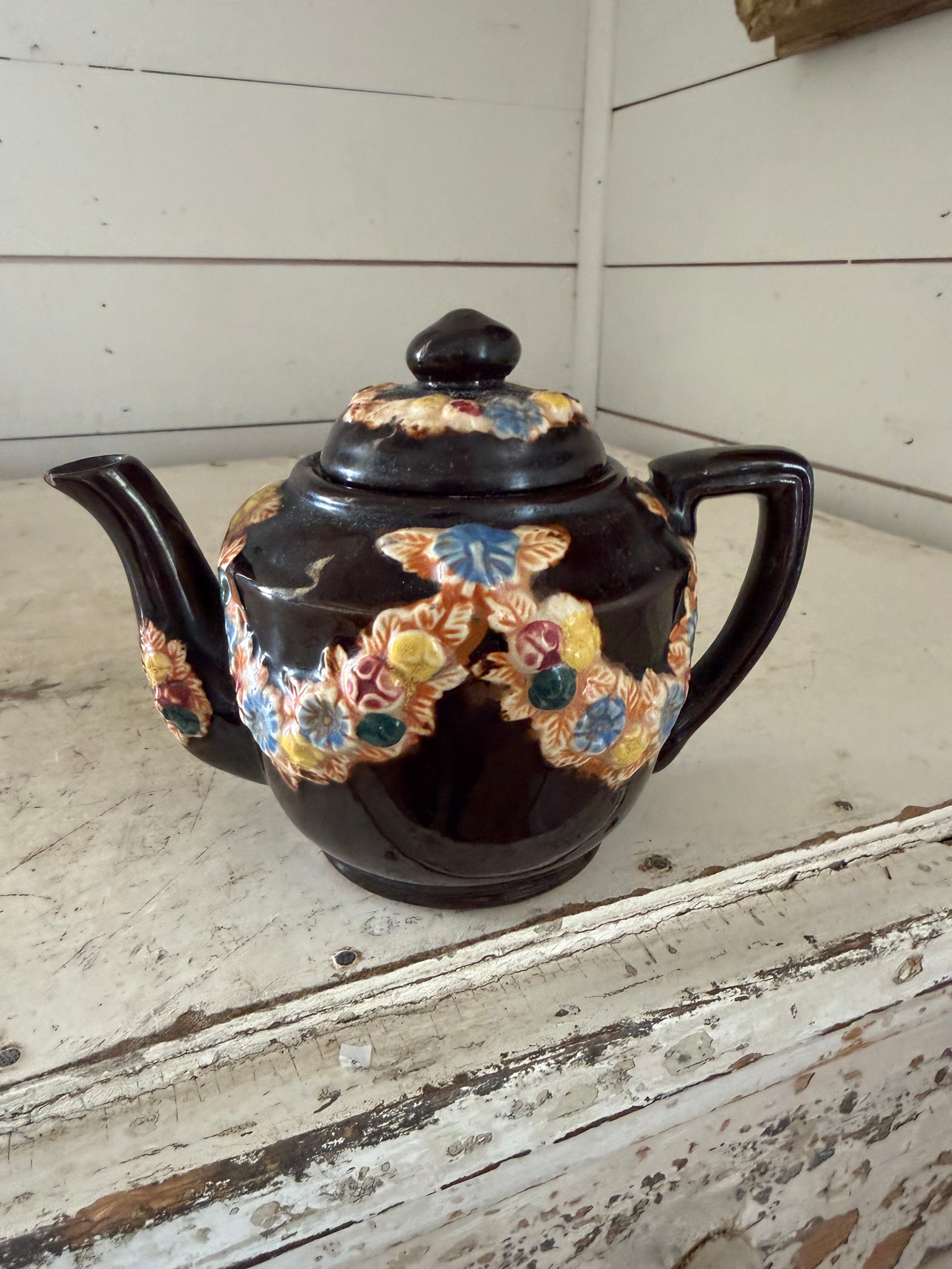 vintage Japanese redware teapot featuring a dark brown glaze