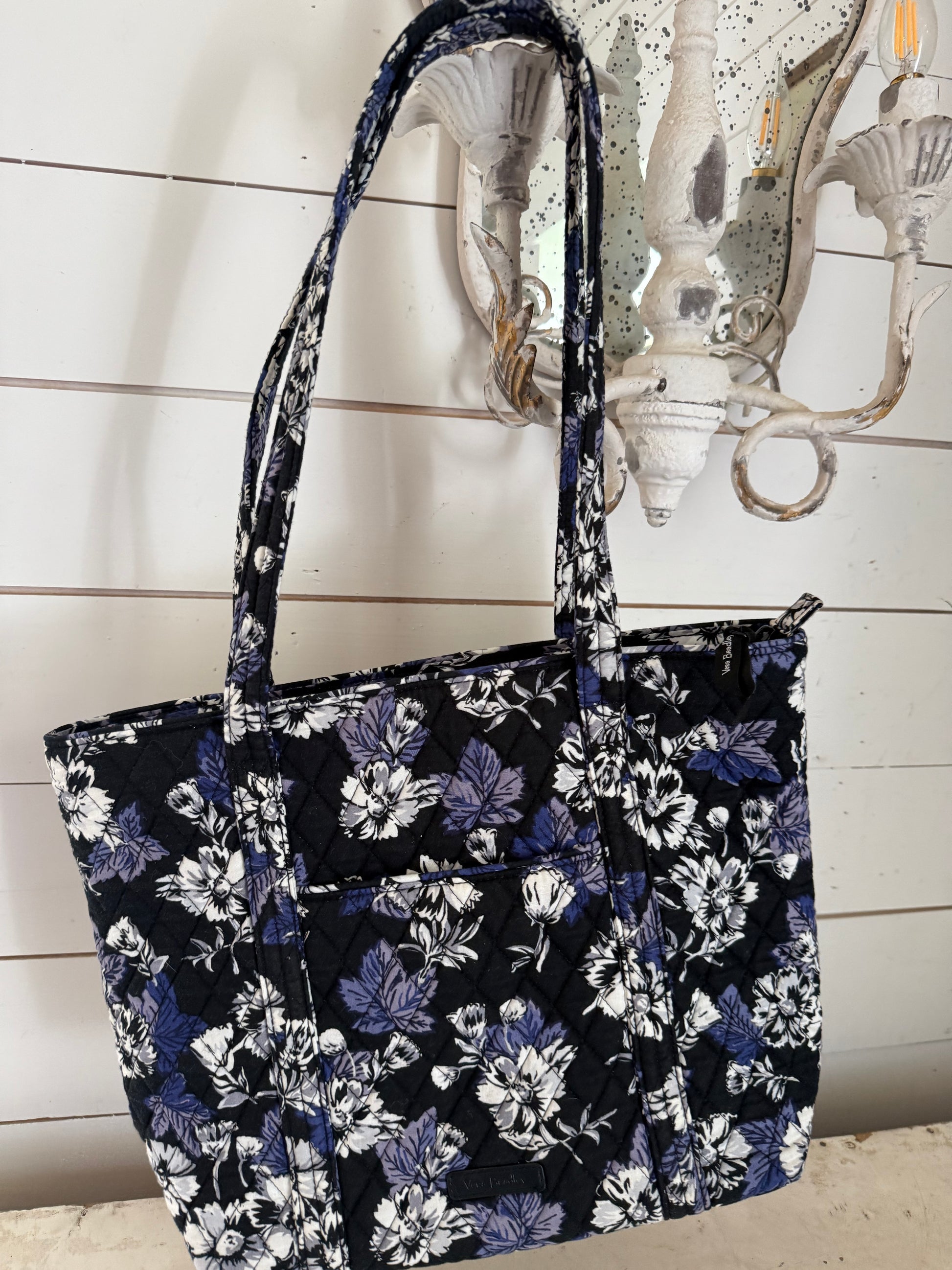 Vera Bradley travel tote bag with a black and blue floral pattern