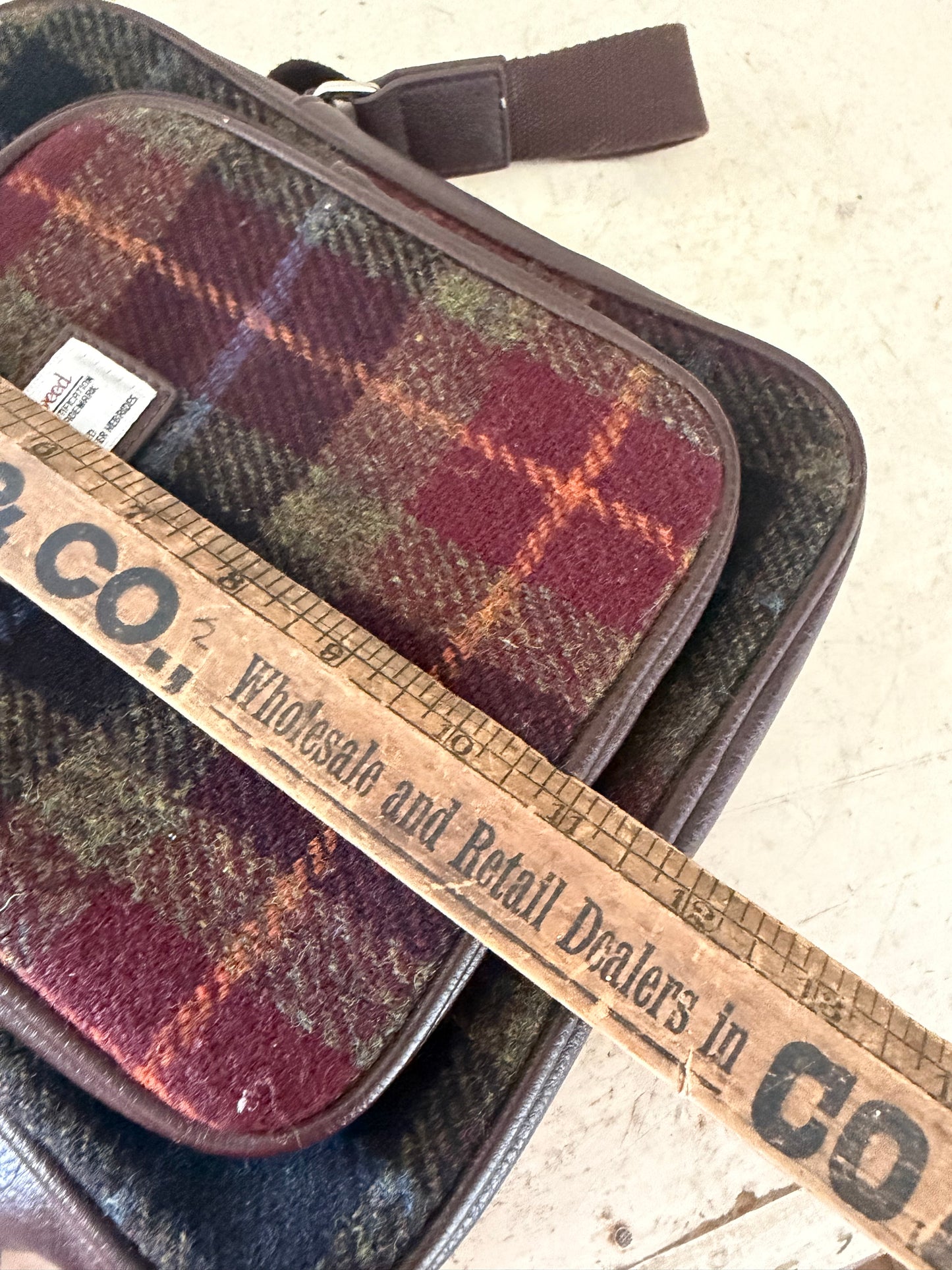 Glen Appin Harris Tweed Tay travel bag featuring a multi-colored tartan pattern and brown trim