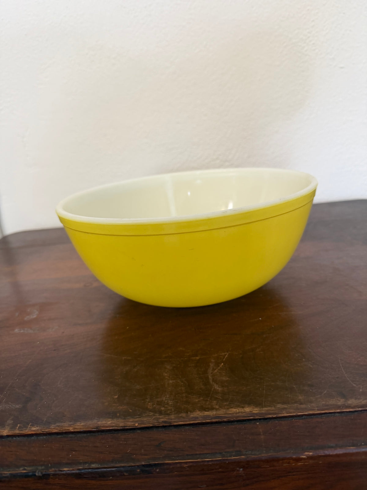 Vintage yellow Pyrex Mixing Bowl with a white interior - Has Some Wear