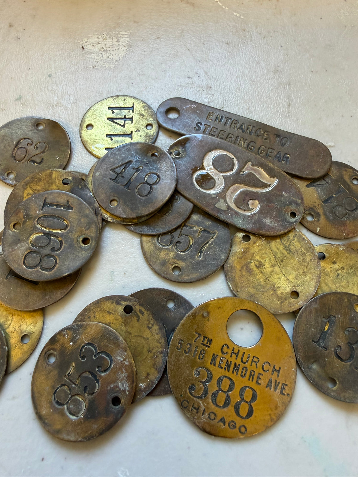 Set of 24 vintage brass locker tags