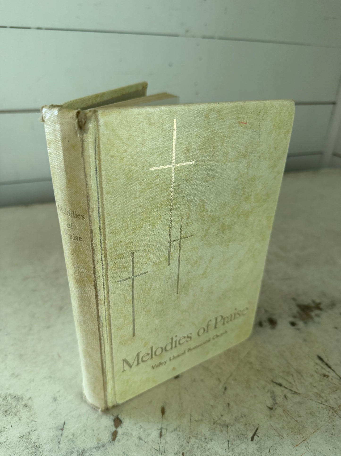 1957 edition of the "Melodies of Praise" church hymnal published by the Gospel Publishing House.