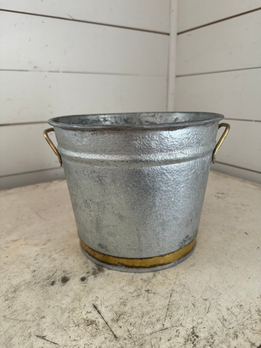 Metal bucket with brass accents