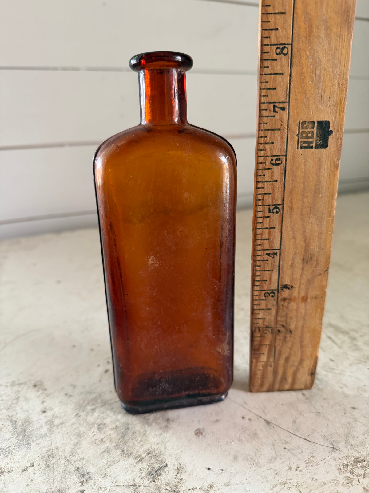 Antique Amber cork stop bottle with decorative seams on the sides
