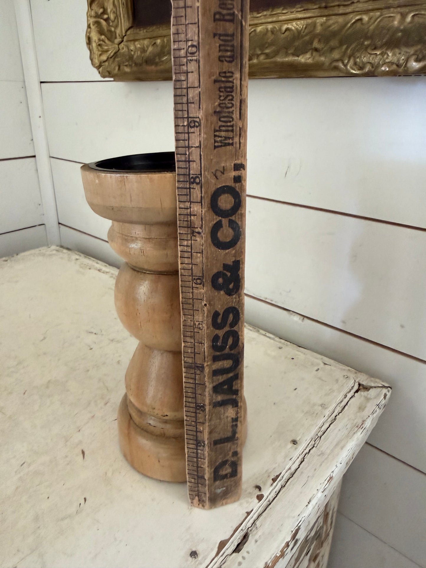 Wood finished candlestick holder features a traditional turned baluster design