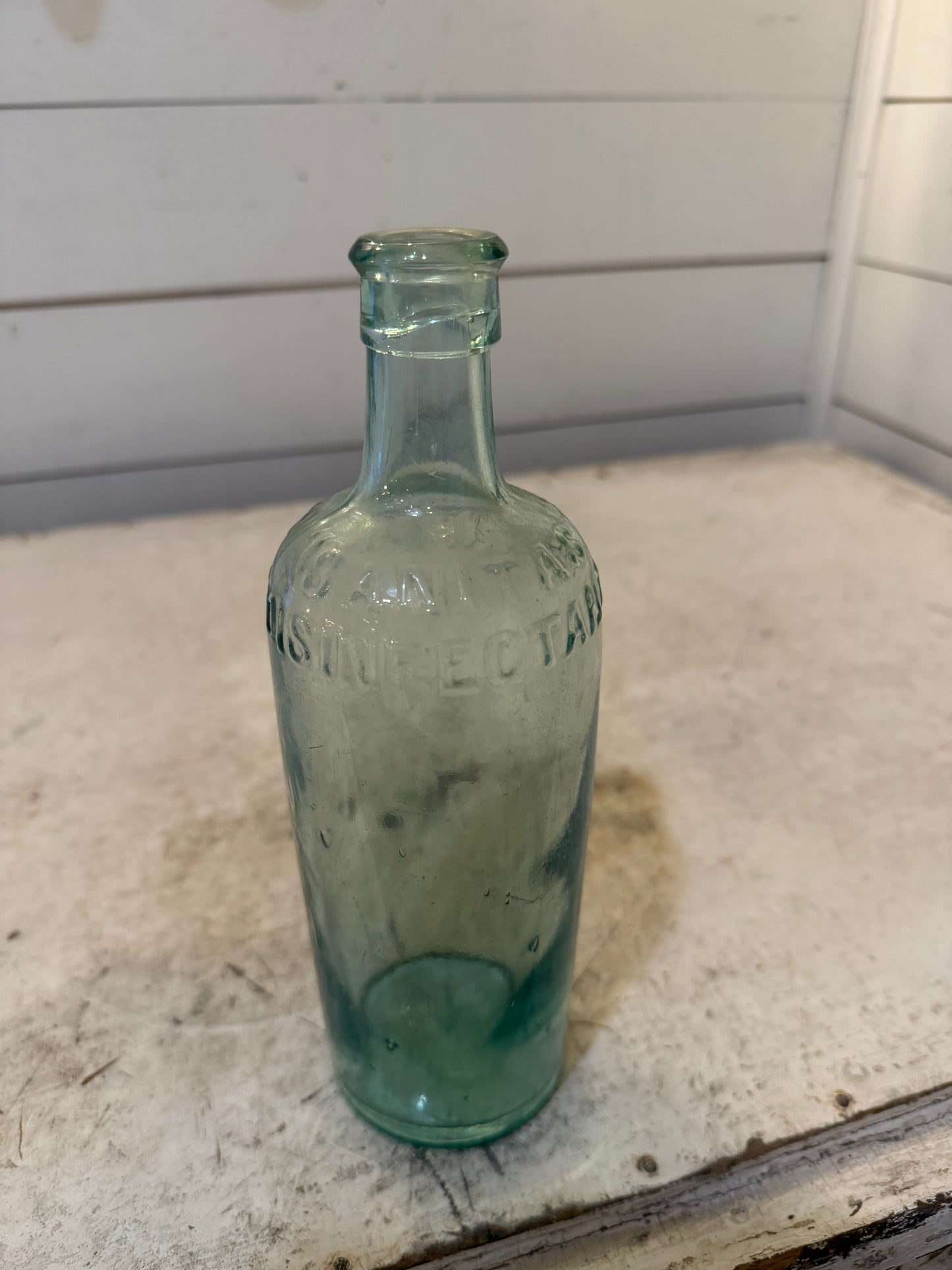 19th Century Sanitas Disinfectant aqua-colored bottle