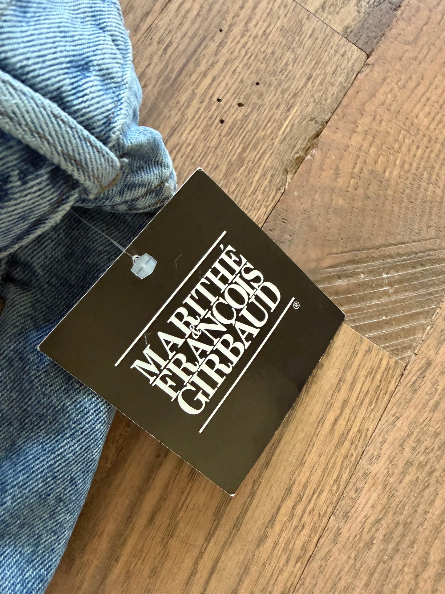 90’s vintage Marithé + François Girbaud denim jeans featuring a black brand hangtag on light-wash material 32 cowboy jean new with tag