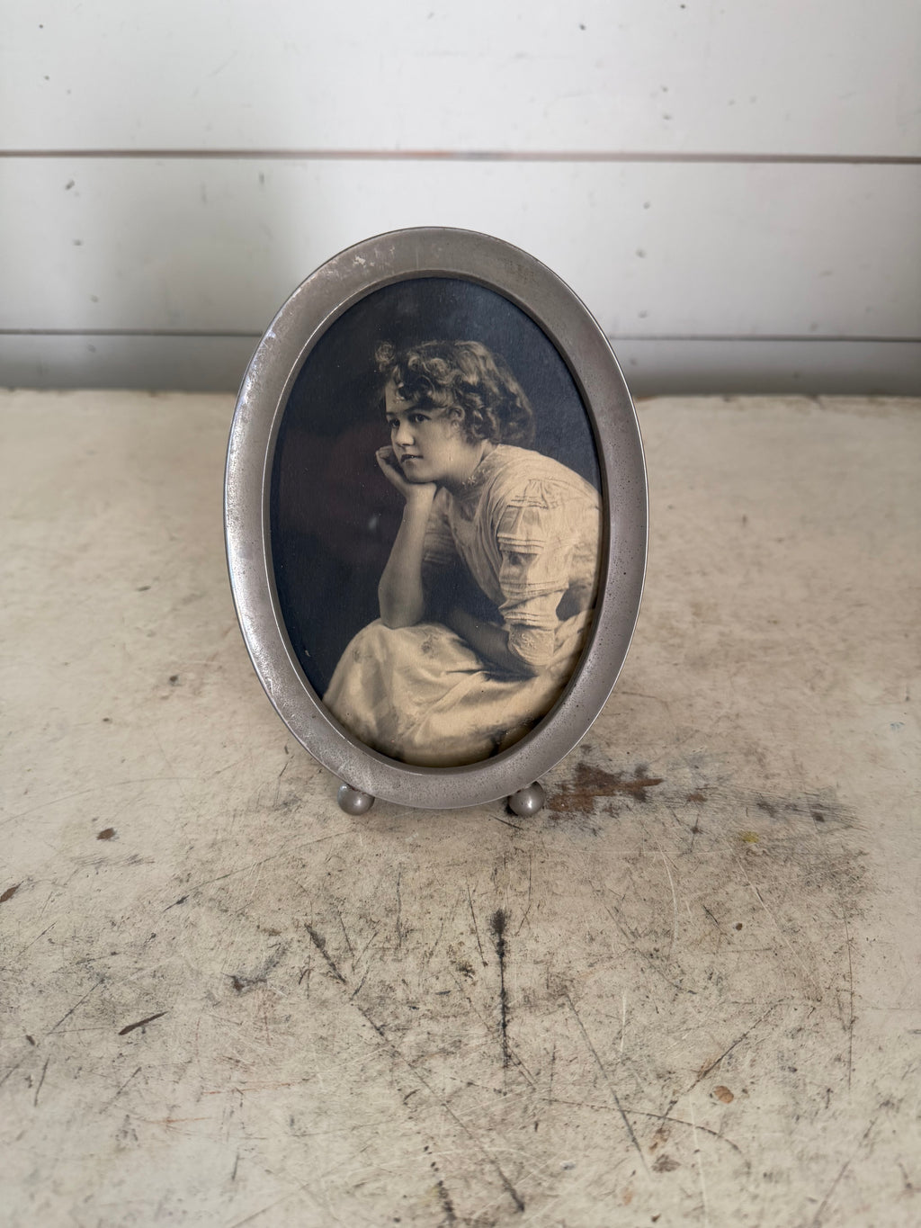 Vintage oval frame with black and white portrait of a woman