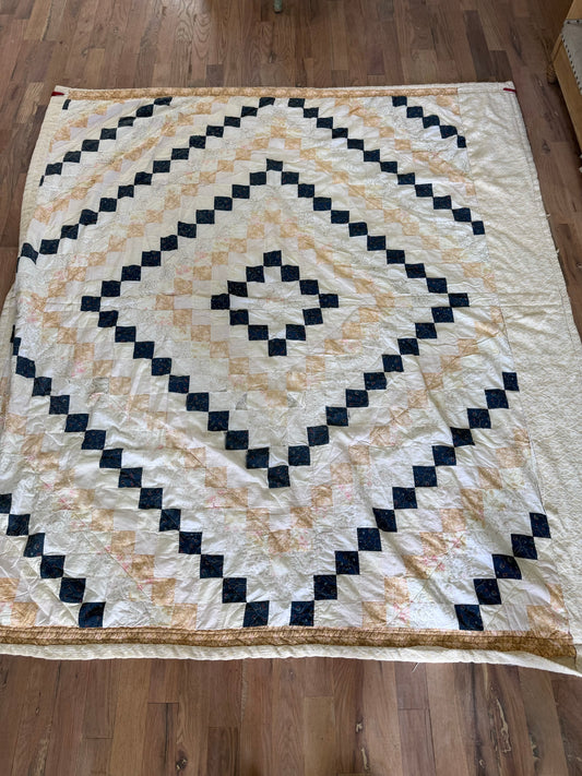 Hand made quilt with diamond pattern - has rips