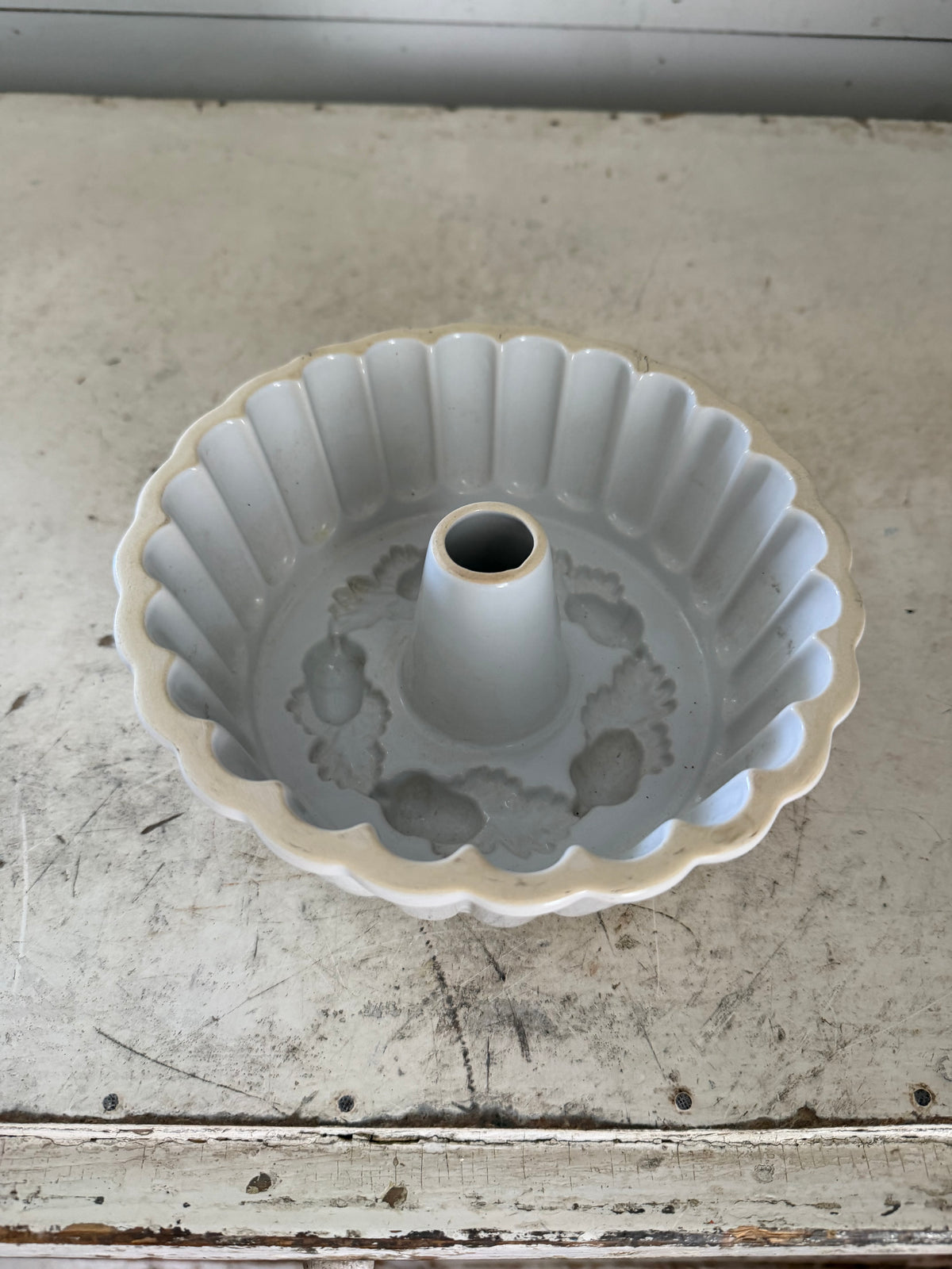 White Ceramic ring mold decorated with a raised acorn and oak leaf pattern