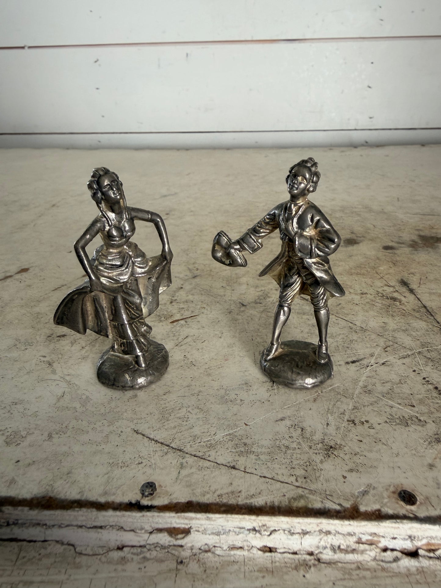 Pair of vintage pewter figurines depicting a courting lady and gentleman