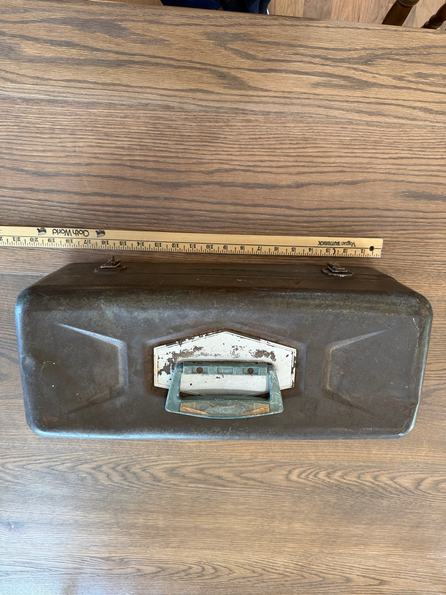 Vintage metal tackle box has dents and wear consistent with Age