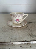 Vintage porcelain teacup and saucer with gold filigree