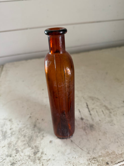 Antique Amber cork stop bottle with decorative seams on the sides