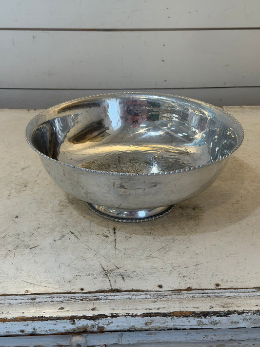 Vintage hand-wrought aluminum serving bowl with a floral design in the center and a scalloped rim