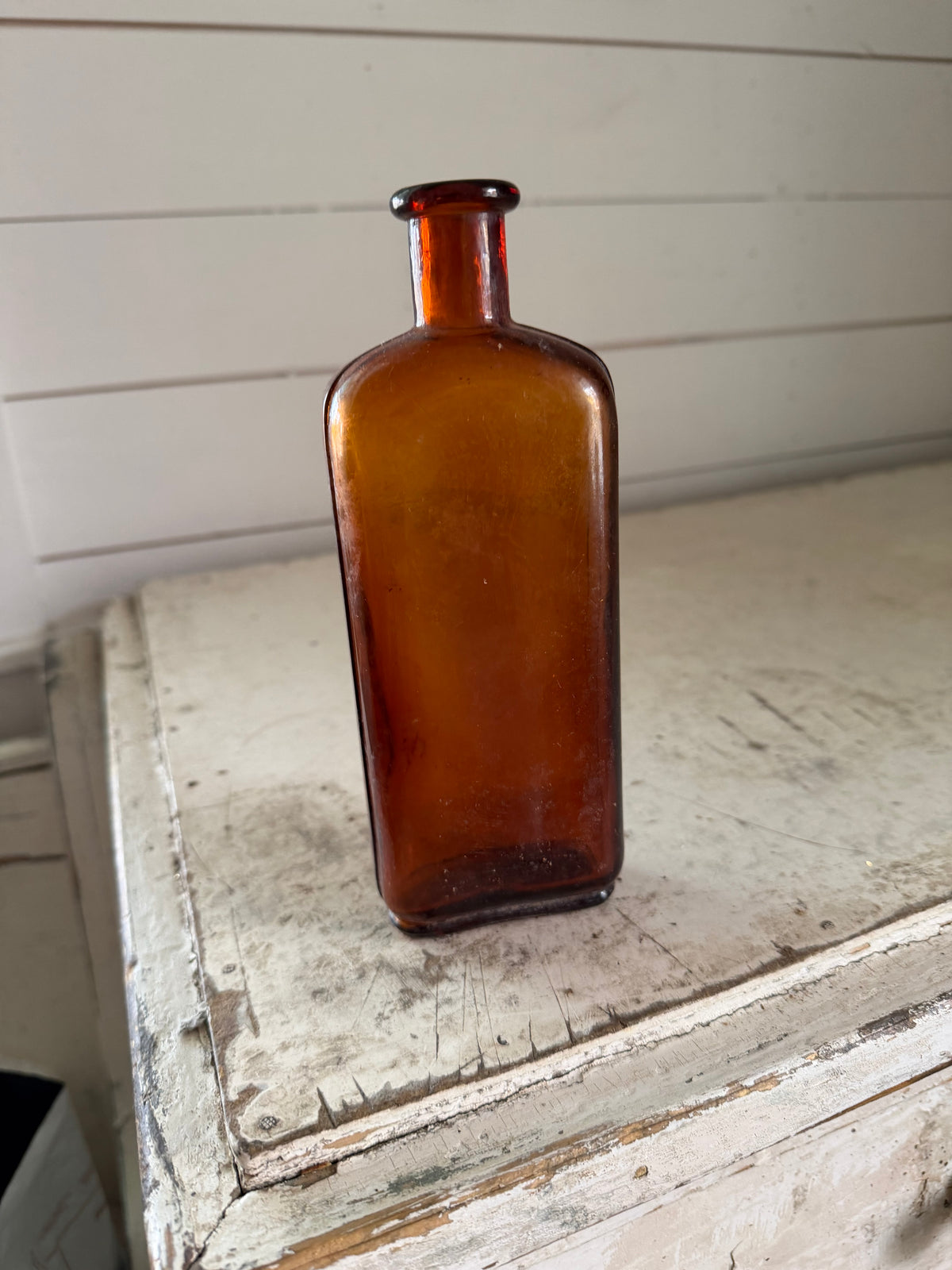 Antique Amber cork stop bottle with decorative seams on the sides