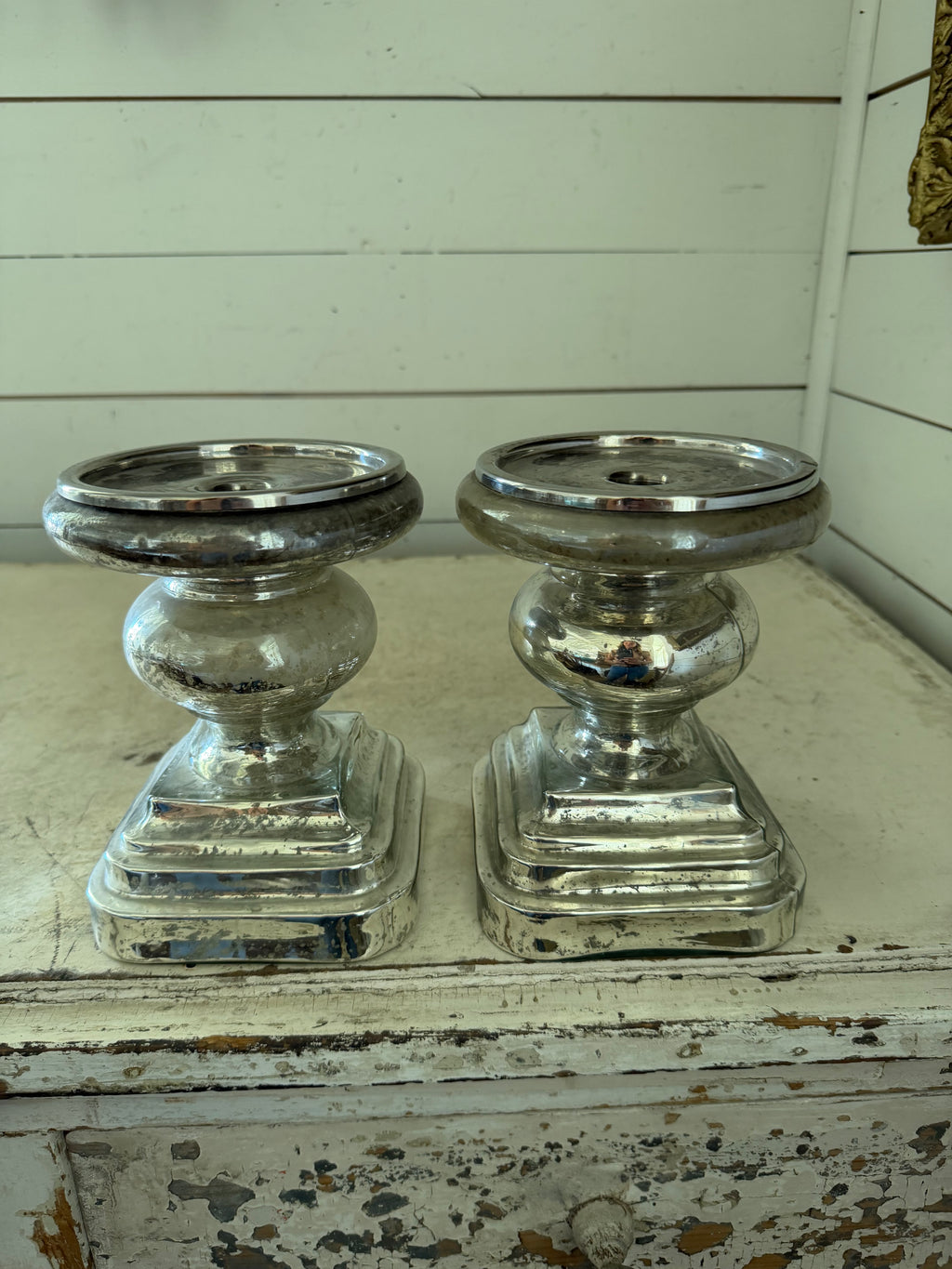 Set of mercury glass  finished candlestick holder features a traditional turned baluster design
