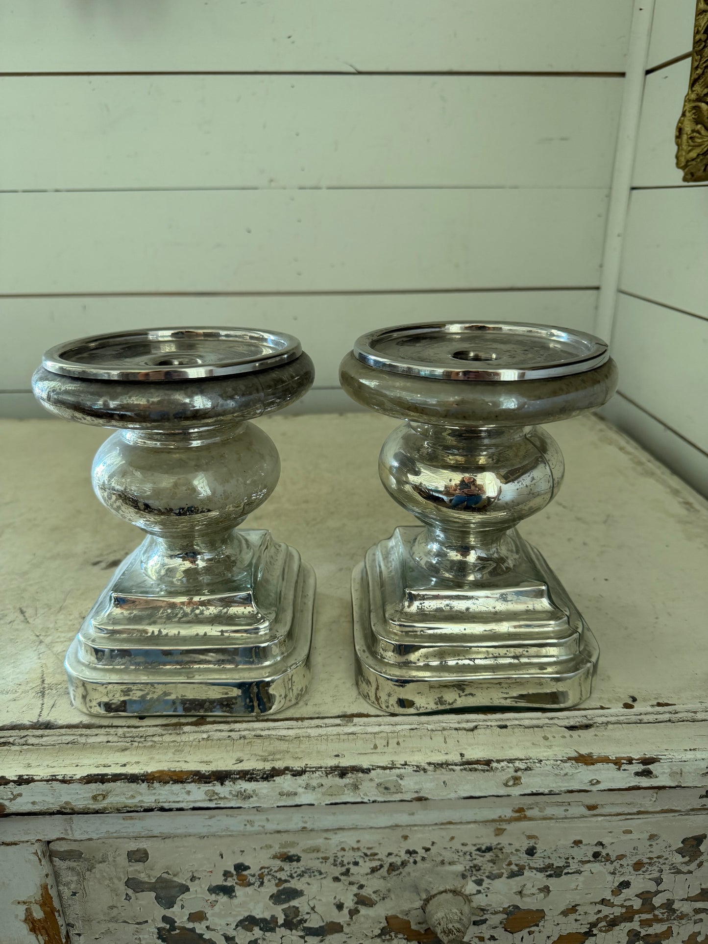 Set of mercury glass  finished candlestick holder features a traditional turned baluster design