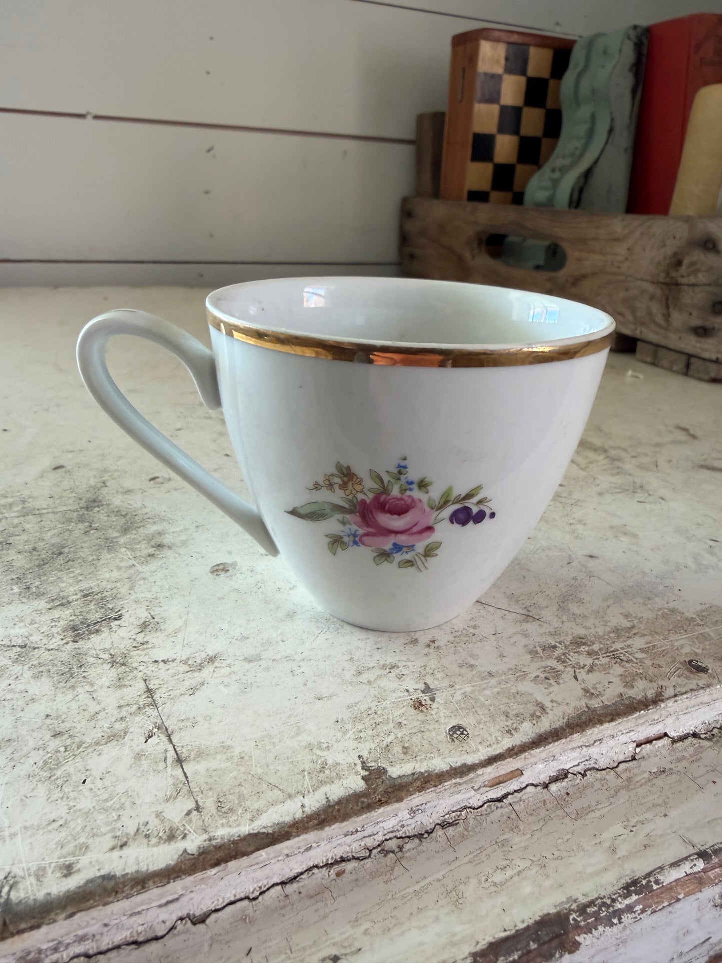 Vintage bone china teacup with a floral pattern and gold trim