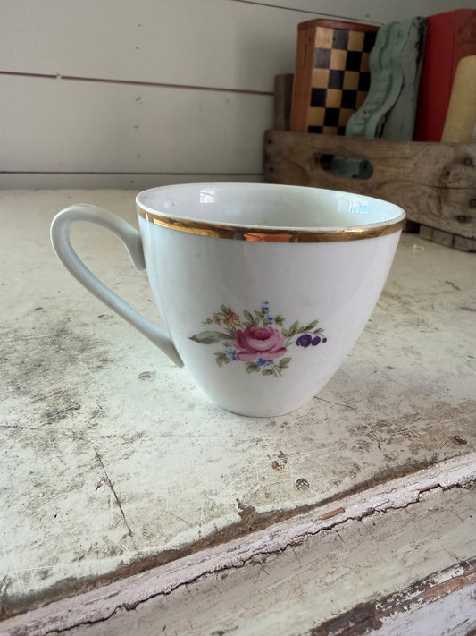 Vintage bone china teacup with a floral pattern and gold trim
