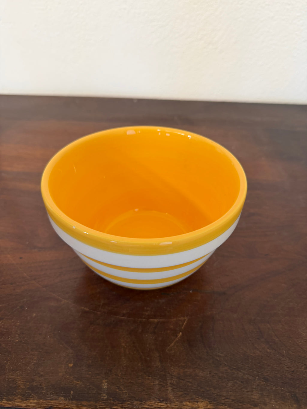 Yellow and white ceramic striped bowl