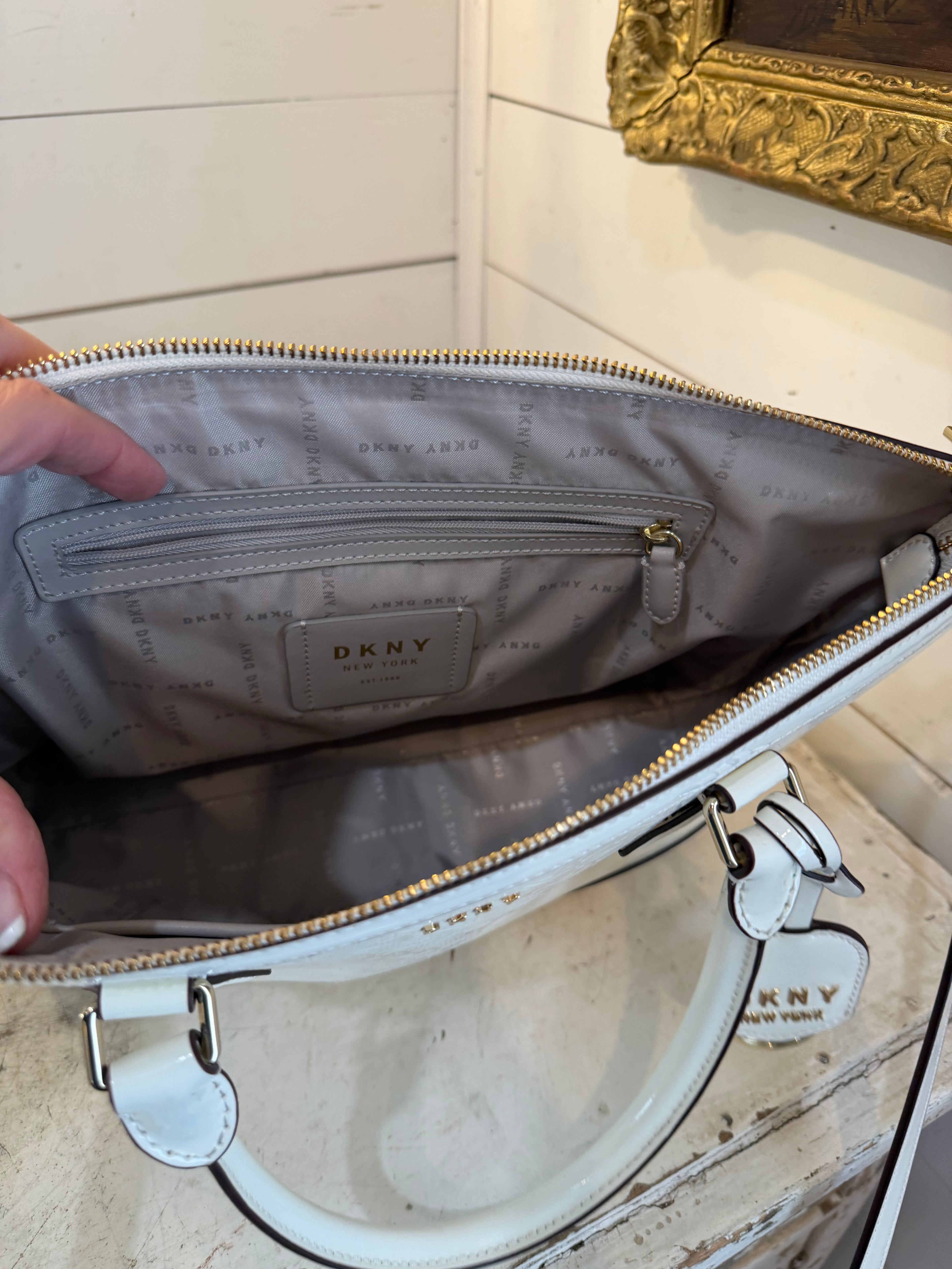 DKNY Hadlee small tote bag in a patent material with a removable shoulder strap has small scuffs