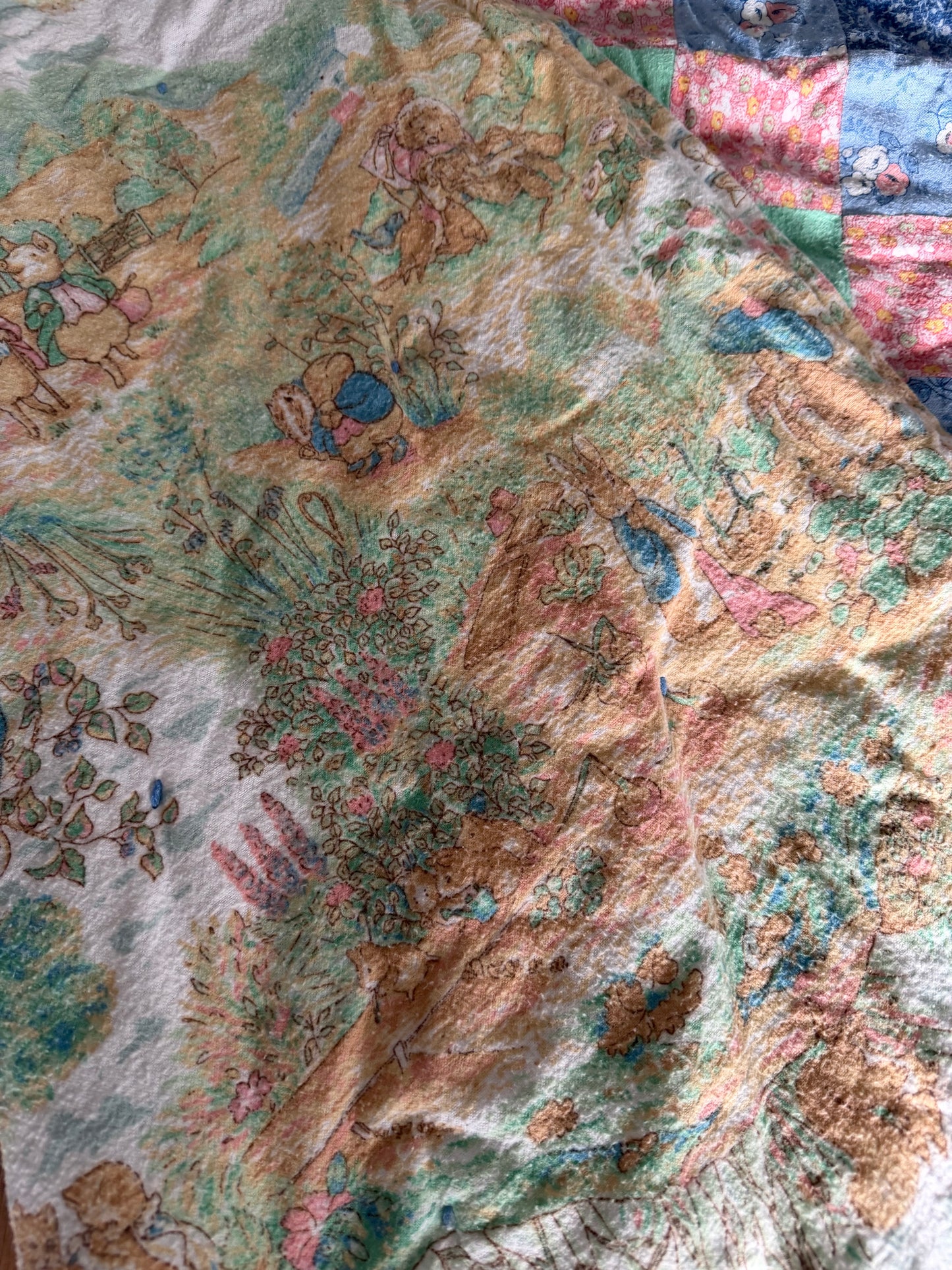 Pieced baby blanket quilt with Peter rabbit backer