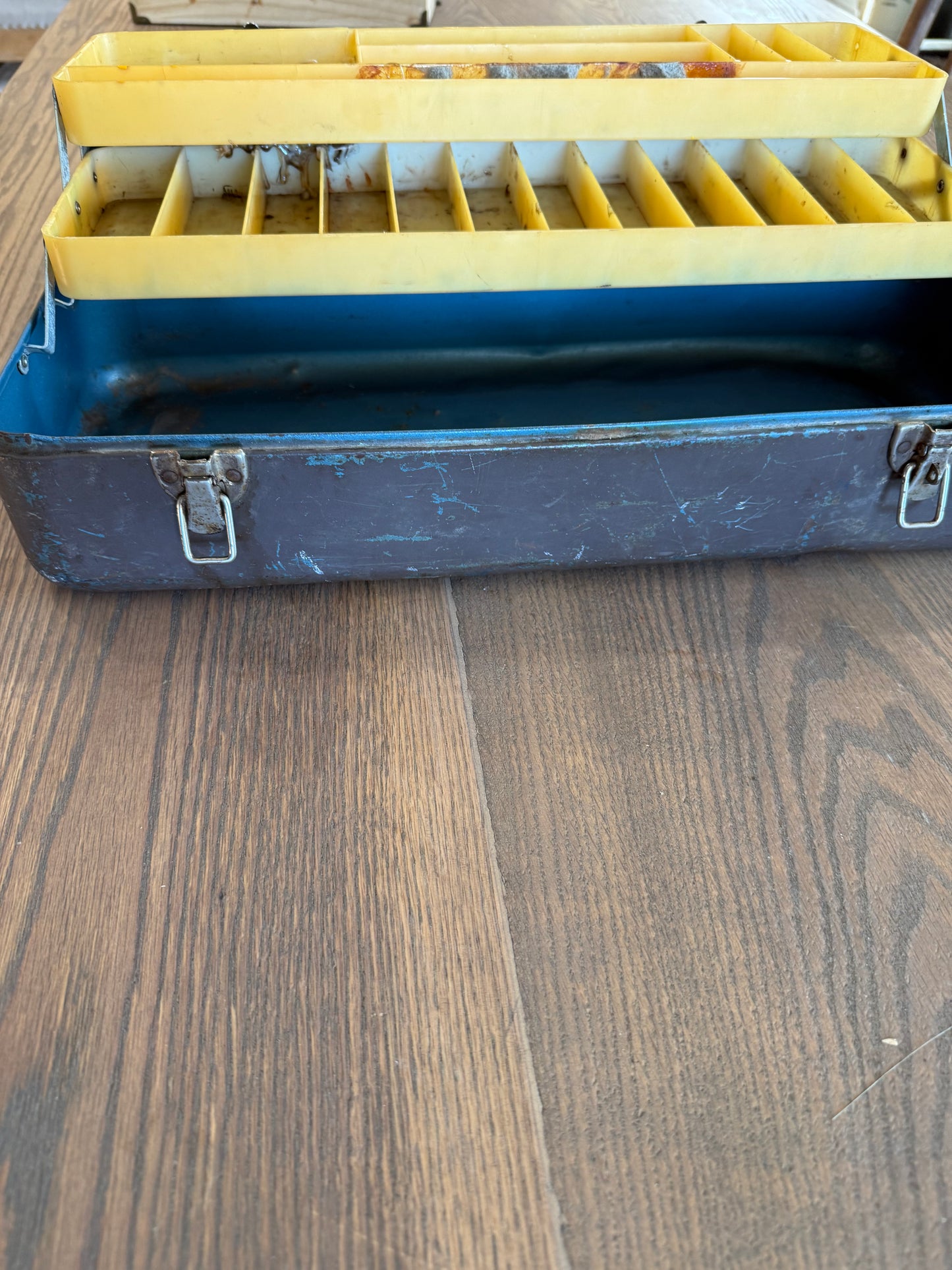 Vintage metal tackle box has dents and wear consistent with Age