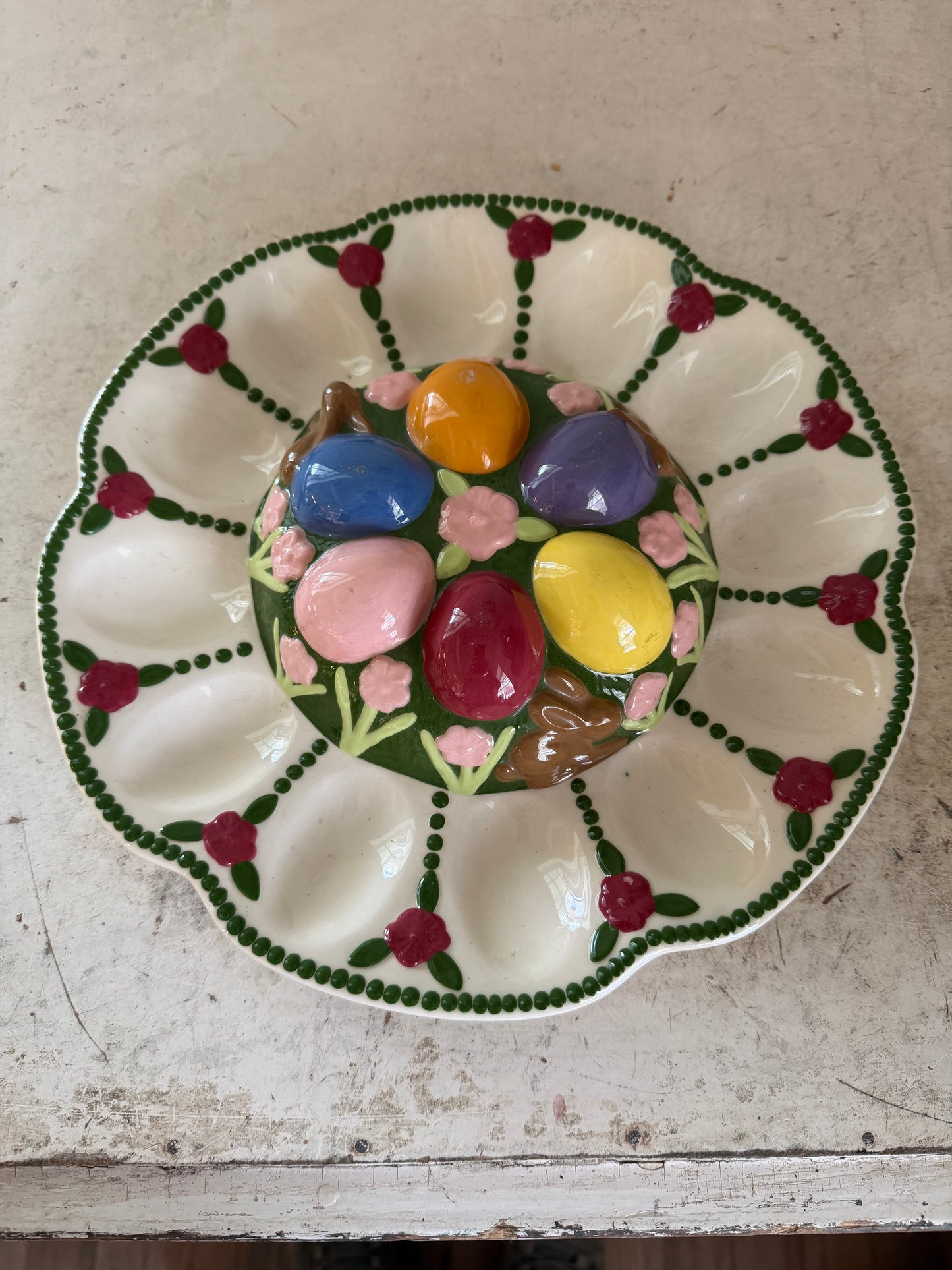 Vintage Easter deviled egg platter with chocolate bunnies, and flowers on it
