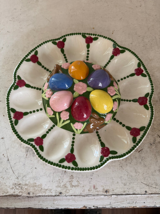 Vintage Easter deviled egg platter with chocolate bunnies, and flowers on it