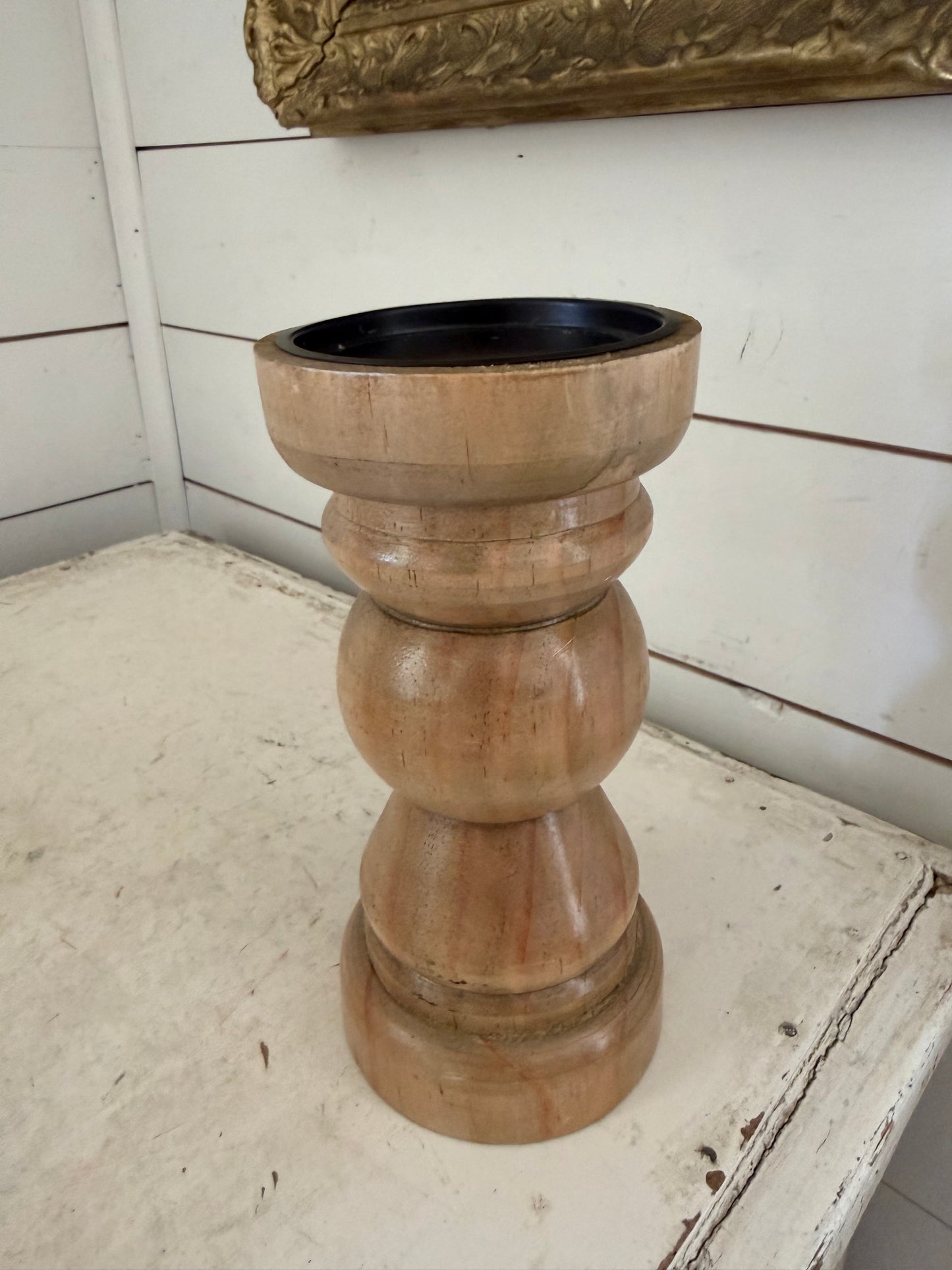 Wood finished candlestick holder features a traditional turned baluster design