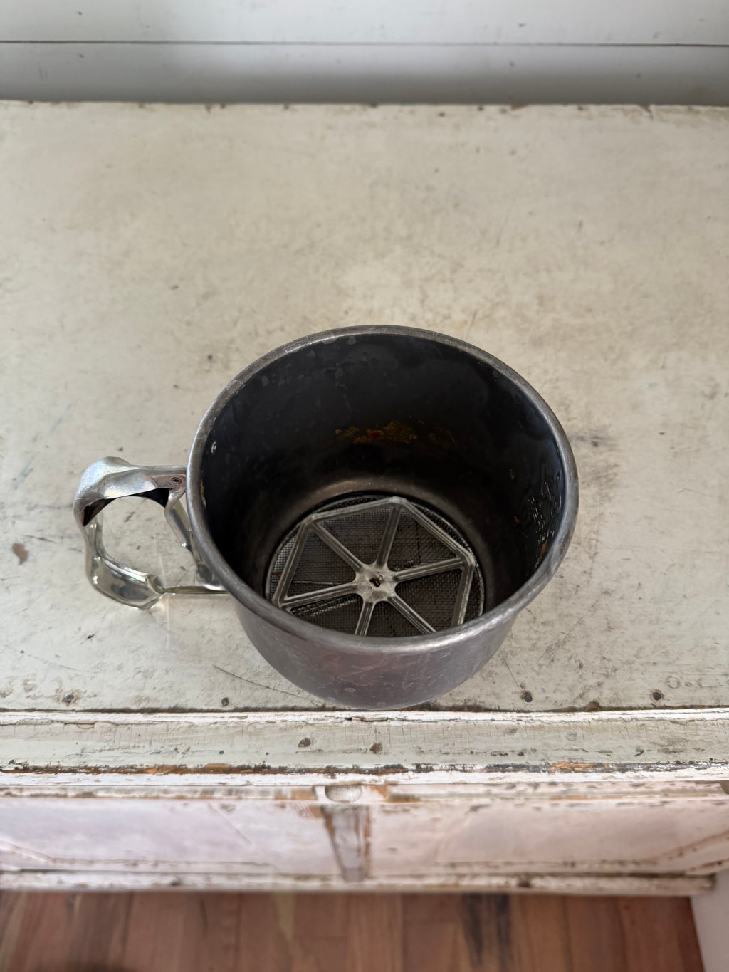 Vintage Foley 5-cup aluminum flour sifter with a squeeze-action handle