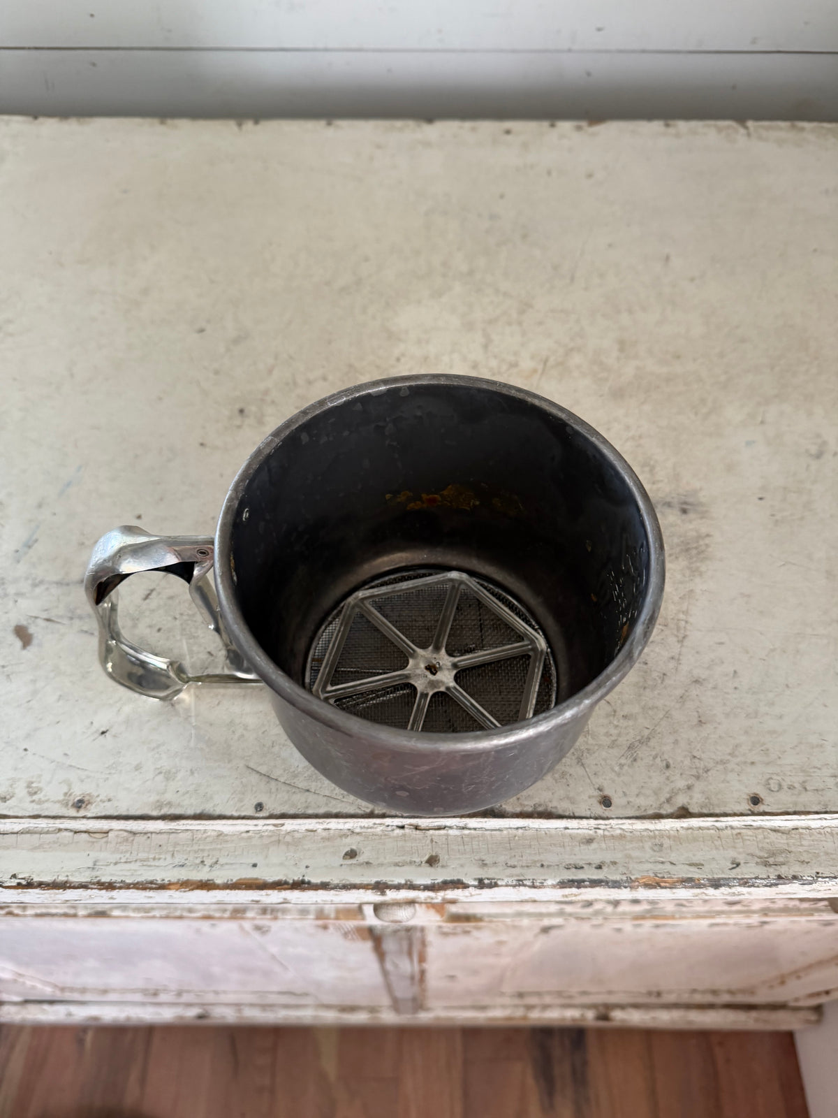 Vintage Foley 5-cup aluminum flour sifter with a squeeze-action handle