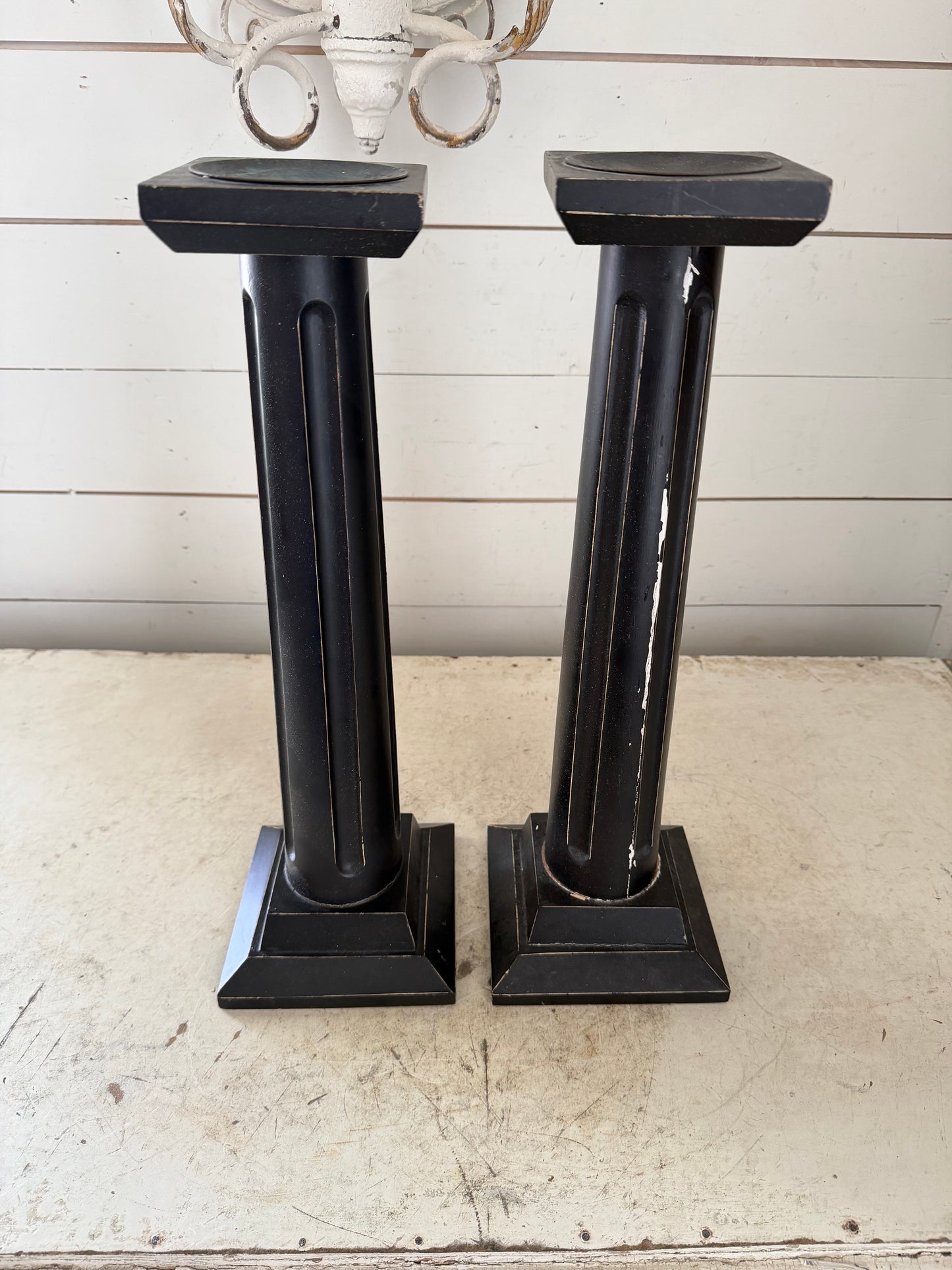 Set up two large black pillar candlesticks will get makeover